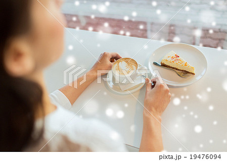 close up of woman hands with cake and coffee close up of woman hands with cake and coffee 19476094