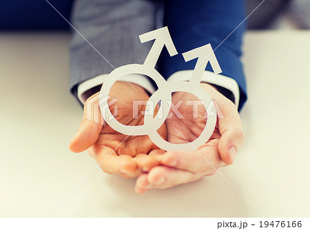 close up of happy male gay couple with love symbol 19476166
