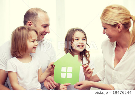smiling parents and two little girls at new home smiling parents and two little girls at new home 19476244