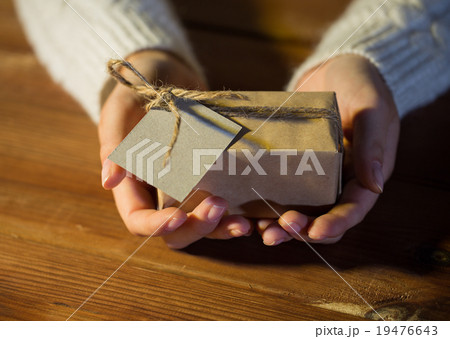 close up of woman with christmas gift or parcel 19476643