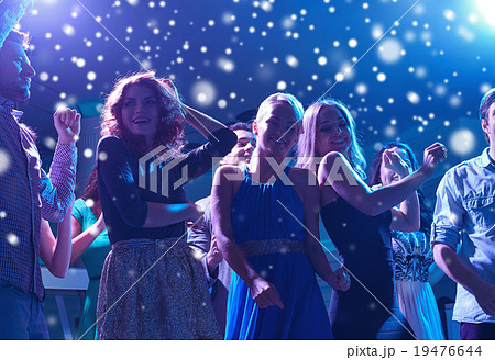 group of happy friends dancing in night club 19476644