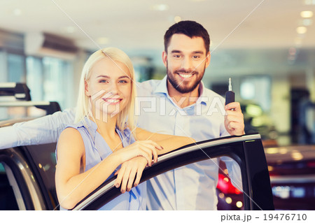 happy couple buying car in auto show or salon 19476710