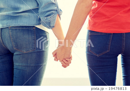 close up of lesbian couple holding hands 19476813