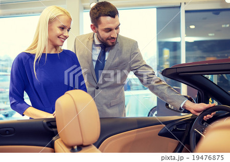 happy couple buying car in auto show or salon happy couple buying car in auto show or salon 19476875