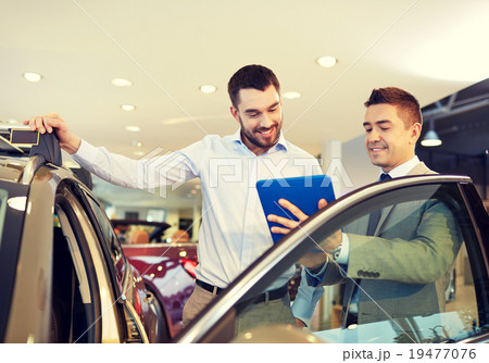 happy man with car dealer in auto show or salon 19477076
