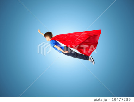 boy in red superhero cape and mask flying on air 19477289