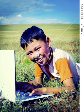 Mongolian Boy Laptop Grass Technology Connection Concept 19483395