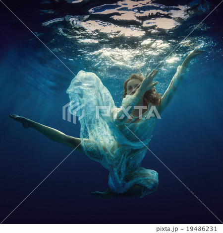 The girl in a beautiful dress under water. The girl in a beautiful dress under water. 19486231