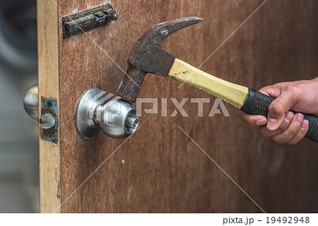 Thief with of hammer in the hand to open a door Thief with of hammer in the hand to open a door 19492948
