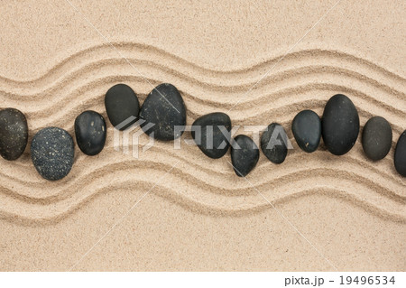 Black stones on the sand Black stones on the sand 19496534