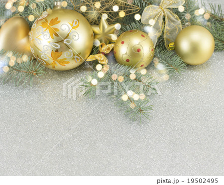 Golden colored Christmas ornaments on a fir tree 19502495