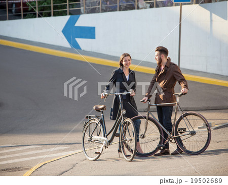 Young couple with on a bicycle opposite city  19502689