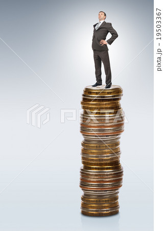 Businessman on coins pile 19503367