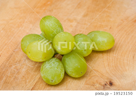 White Raisin isolated on wooden background 19523150