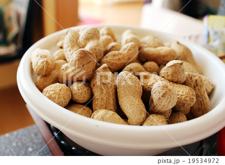 Detail of delicious peanuts in white bowl Detail of delicious peanuts in white bowl 19534972