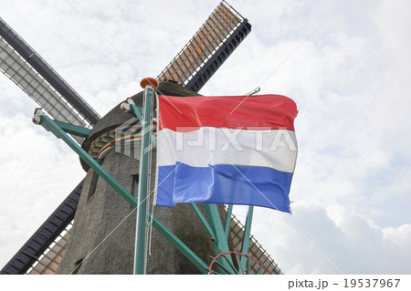 Dutch flag in front of an old  windmill 19537967