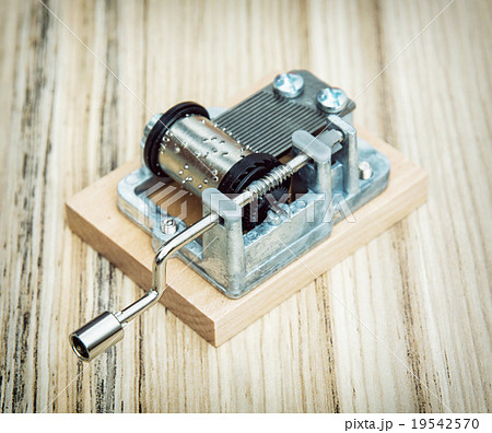 Old little music box on the wooden background Old little music box on the wooden background 19542570