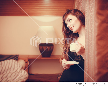 Woman drinking hot coffee beverage at home Woman drinking hot coffee beverage at home 19543963