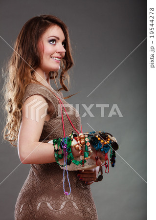 Pretty woman with jewelry necklaces beads and hat. 19544278