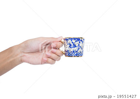 Hand holding classic luxury porcelain cup,isolated 19551427