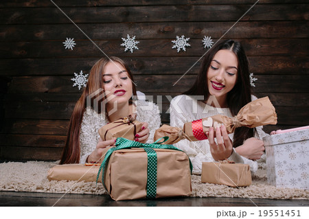 Two beautiful girls lie on the floor 19551451