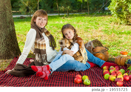 Happy mother with little daughter in autumn park Happy mother with little daughter in autumn park 19555725