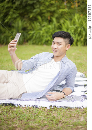 A man taking self-portrait in a park. A man taking self-portrait in a park. 19567521
