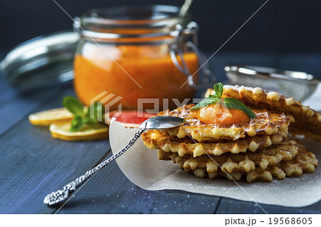 Wafers with drop of jam and silver spoon on paper Wafers with drop of jam and silver spoon on paper 19568605