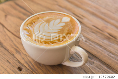 Close up cup of Coffee, latte on the wooden table Close up cup of Coffee, latte on the wooden table 19570602