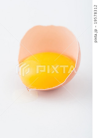 Half of egg with running yolk on the surface. 19578312