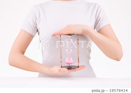 Woman holding three-leveled hourglass. Woman holding three-leveled hourglass. 19578414