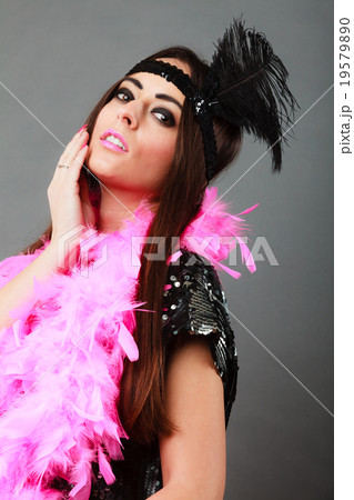 Girl pink plume and black feather on head. Carnival. Girl pink plume and black feather on head. Carnival. 19579890