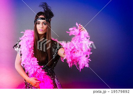 Girl pink plume and black feather on head. Carnival. Girl pink plume and black feather on head. Carnival. 19579892