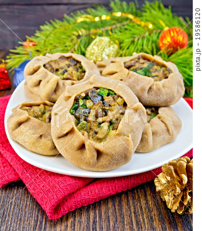 Carols in dish with mushrooms and xmas decorations 19586120