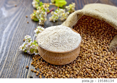 Flour buckwheat in bowl with cereals and flower 19586134