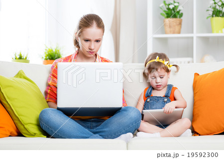 mother and child with computer and tablet at home, according to mother and child with computer and tablet at home, according to 19592300