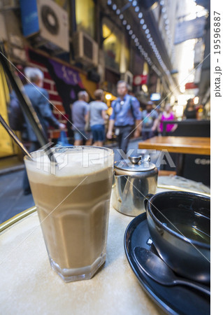 Enjoying coffee and tea in a laneway 19596887