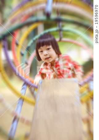 Motion blur Asian little kid playing in the park Motion blur Asian little kid playing in the park 19596970