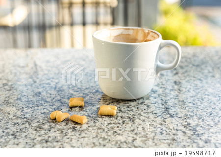 cup of coffee and and some biscuits on the table cup of coffee and and some biscuits on the table 19598717