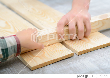 Cheerful father and son making renovation  19603933