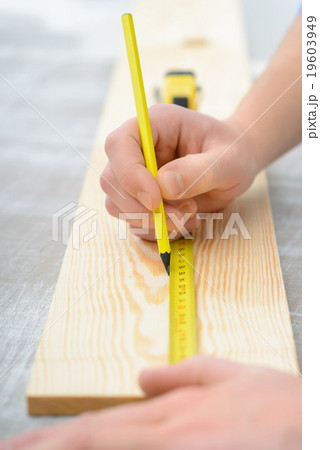 Positive boy holding tape measure Positive boy holding tape measure 19603949