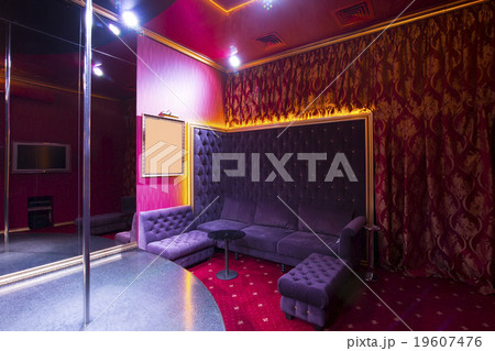 interior strip club with sofas and tables poles 19607476