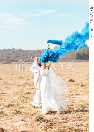 Wedding couple with blue smoke in the park 19620360