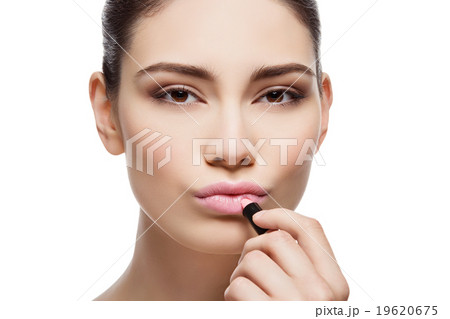 Beautiful girl applying pink lipstick Beautiful girl applying pink lipstick 19620675