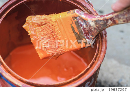 Old paint brush tool in the over the can. 19637297