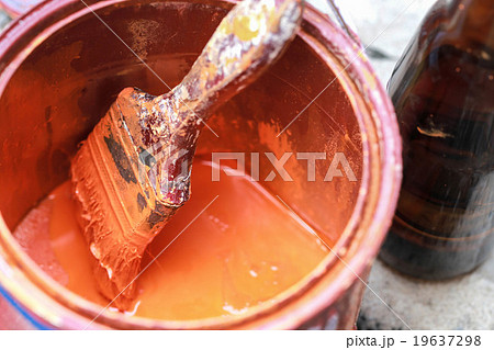 Old paint brush tool in the over the can. 19637298