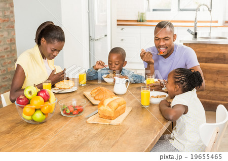 Casual happy family having breakfast 19655465