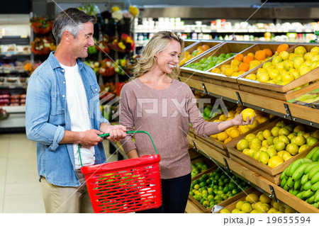 Happy smiling couple picking lemon  19655594