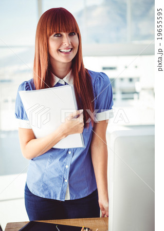 Smiling hipster woman holding document  19655595