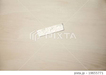Chewing gum wrapper on wooden desk 19655771